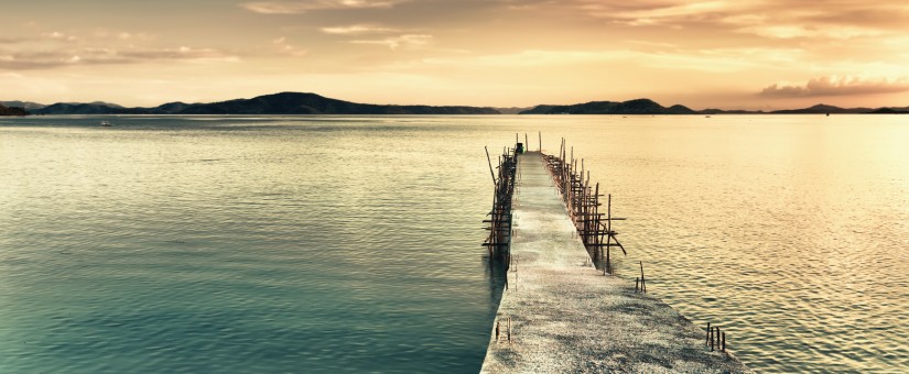 Sunrise over the sea. Pier on the foreground